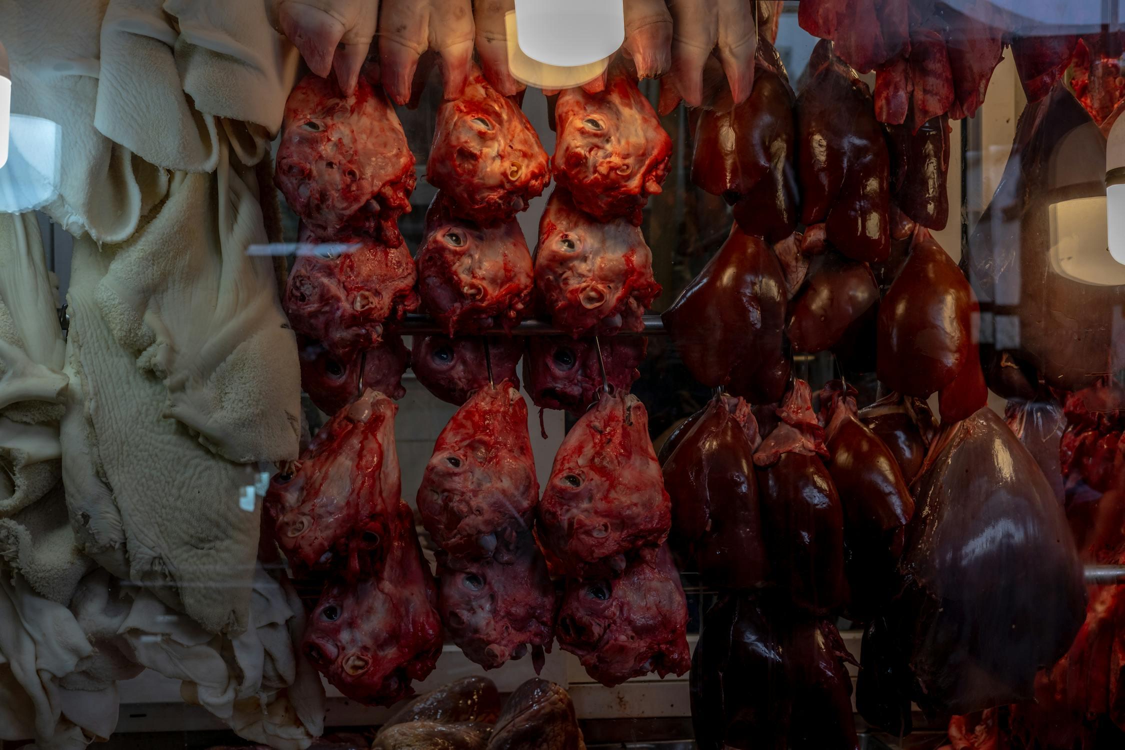 A butcher shop with meat hanging on hooks